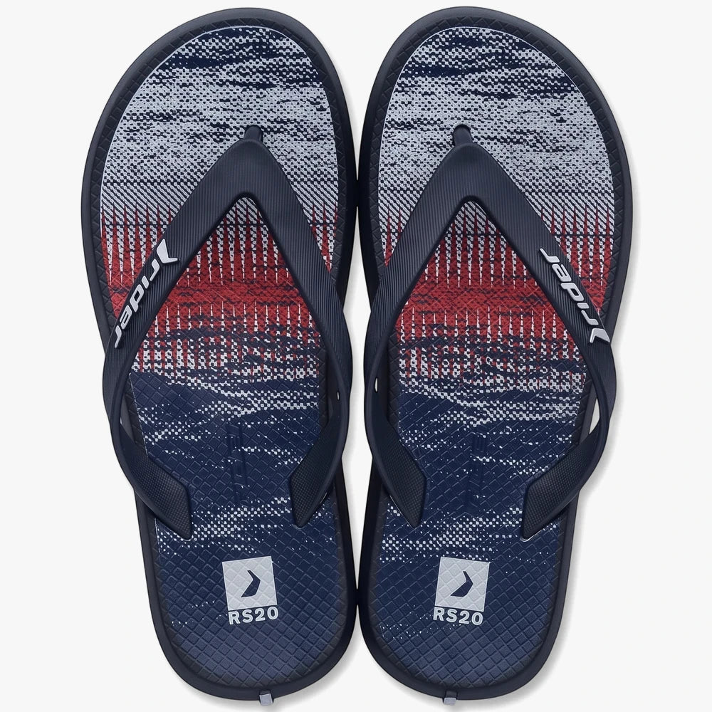 Pair of Rider R1 Play Kids Infants flip-flops in navy with a red, white, and blue abstract patterned sole, viewed from above.