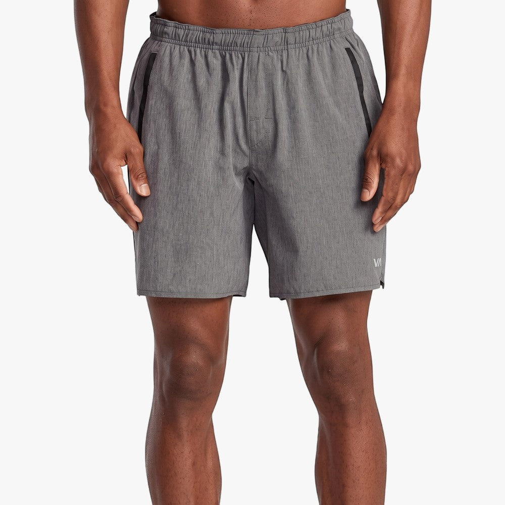 A male model wears charcoal heather gray Rvca Yogger 17" Stretch Shorts, showcasing their athletic fit and performance