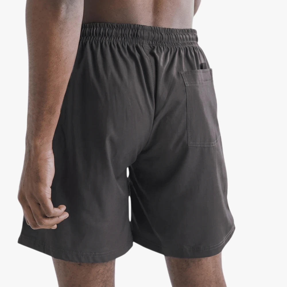 Charcoal gray Saint And Summer Seth plain board shorts for men, shown from the back, featuring an elastic waistband and a