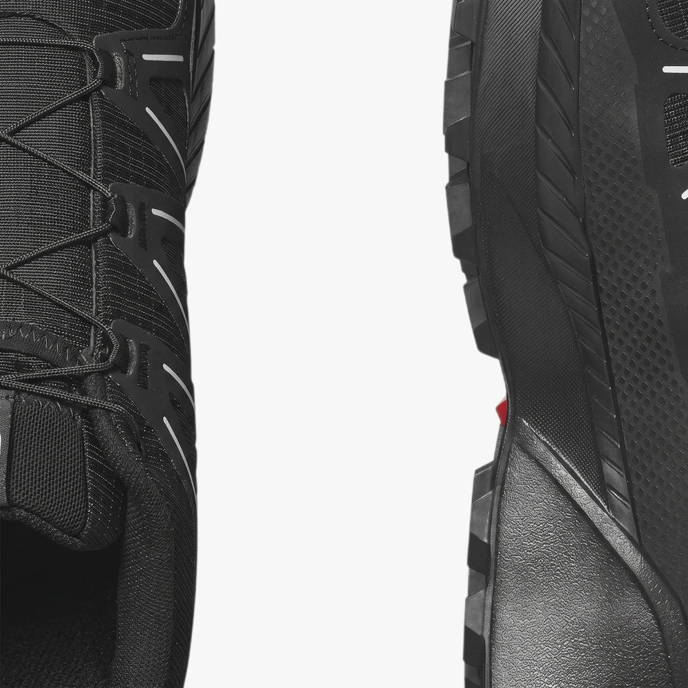 Close-up of Salomon Mens Speedcross Peak Trail Sneakers in black, highlighting the textured mesh upper and rugged outsole.