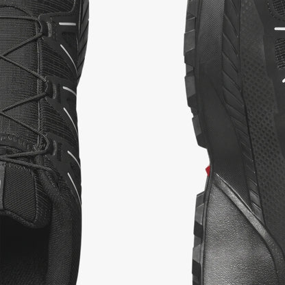 Close-up of Salomon Mens Speedcross Peak Trail Sneakers in black, highlighting the textured mesh upper and rugged outsole.