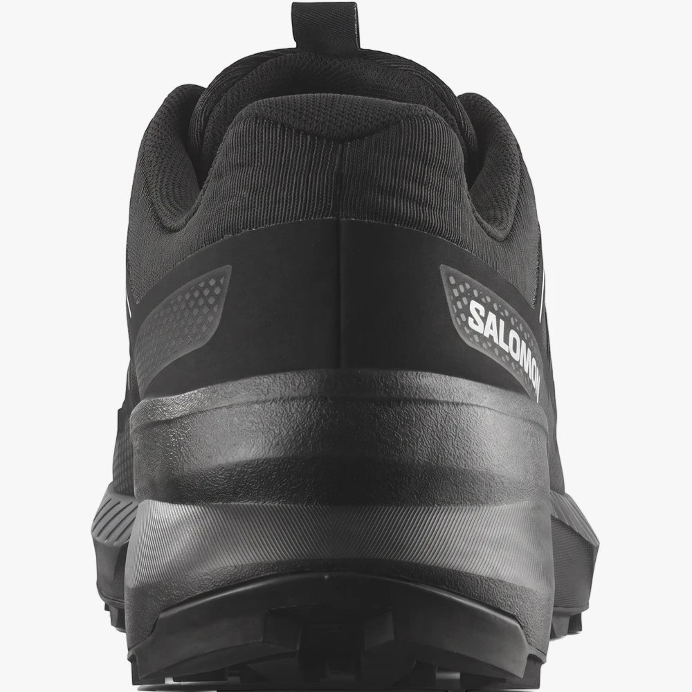 Rear view of a black Salomon Mens Speedcross Peak Trail Sneaker, highlighting the white logo and rugged sole.