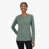 Smiling woman wearing a laurel green Salomon women&