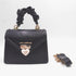 Sissy Boy Black Handbag with a ruched top handle, gold hardware, a white heart-shaped clasp, and a matching detached strap.