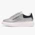 A single Sissy Boy Carter sneaker in silver glitter, featuring a chunky white platform sole and a black heel accent,