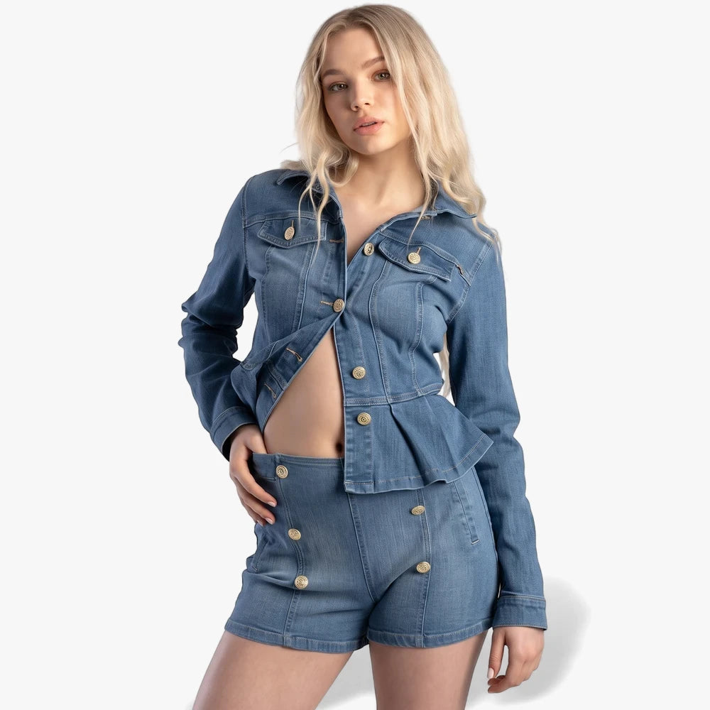 Blonde woman posing in Sissy Boy light vintage high-waist denim shorts with button details and a matching denim jacket.