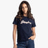 A woman models a navy Sissy Boy regular sequin and pearl short sleeve tee with blue jeans, posing with hand in pocket.