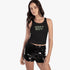 Black Sissy Boy Sun Daze tank top with glitter text worn by a model, paired with black sequin shorts, shown from mid-thigh