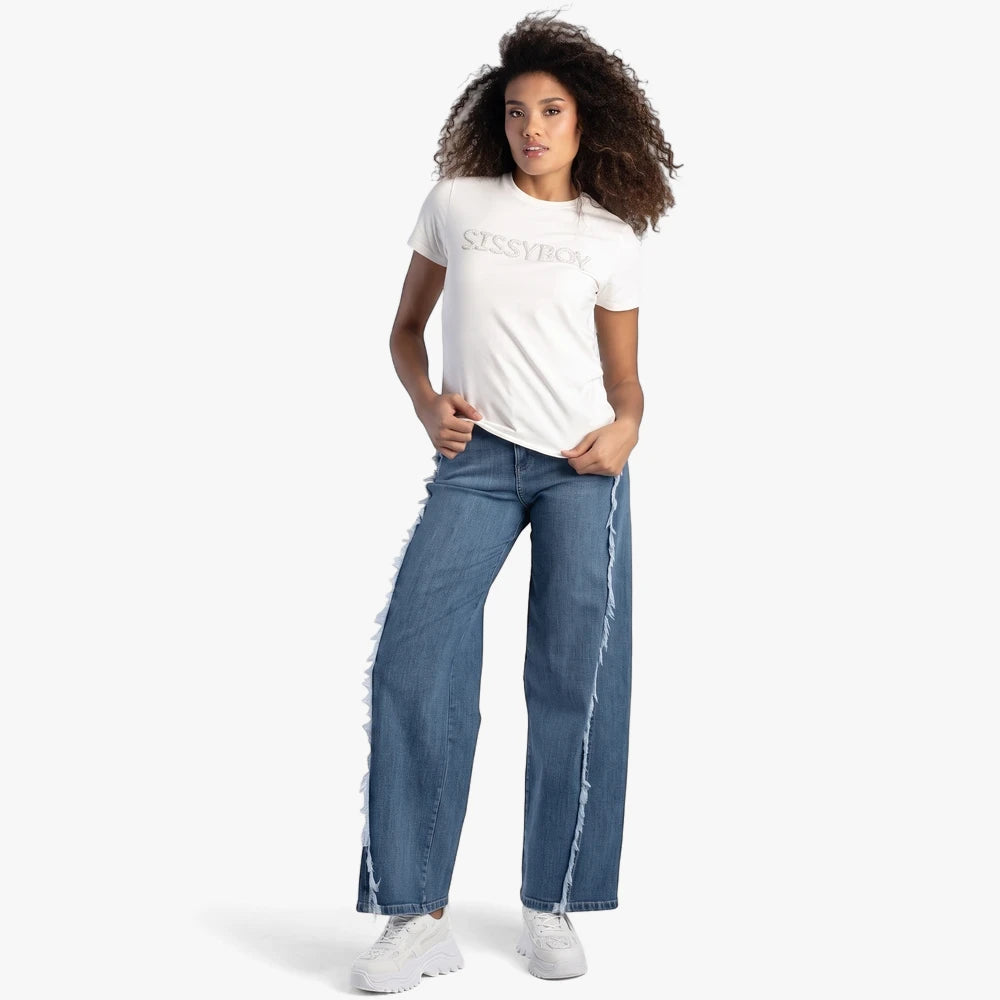 Woman wearing Sissy Boy off-white Pearl Abd Bling Top, blue wide-leg jeans with frayed seams, and white sneakers.
