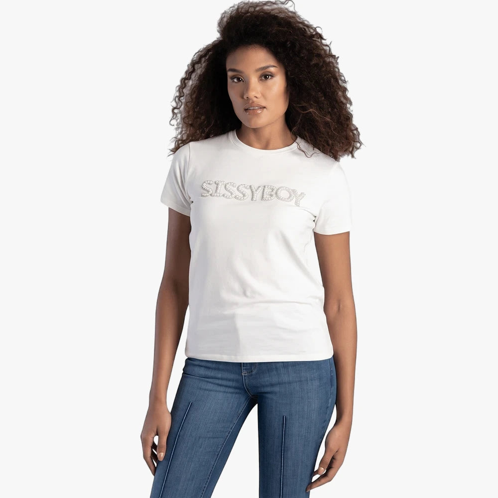 Woman models Sissy Boy Off White Pearl Bling Top and blue jeans on a studio backdrop.