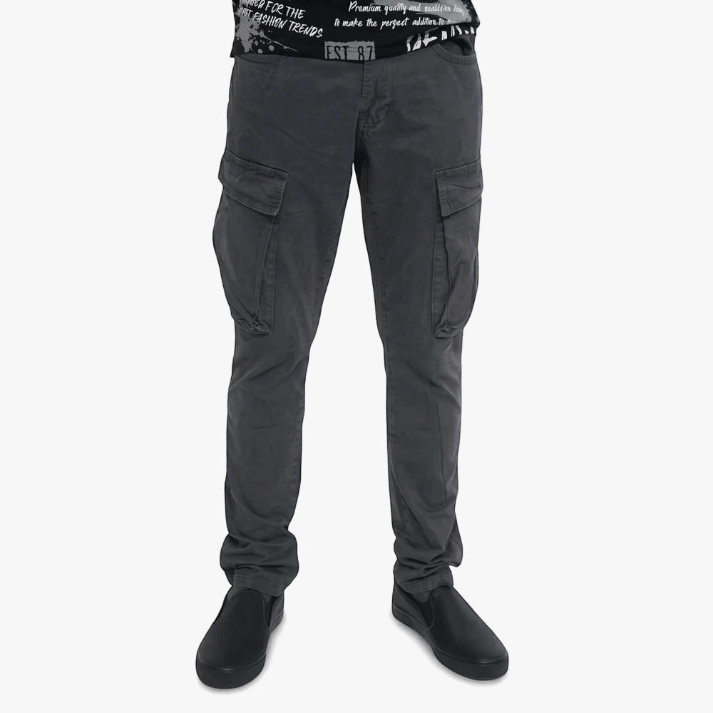 Dark grey Soviet Mens Lotto cargo pants with multiple pockets, worn by a model and paired with black slip-on shoes.