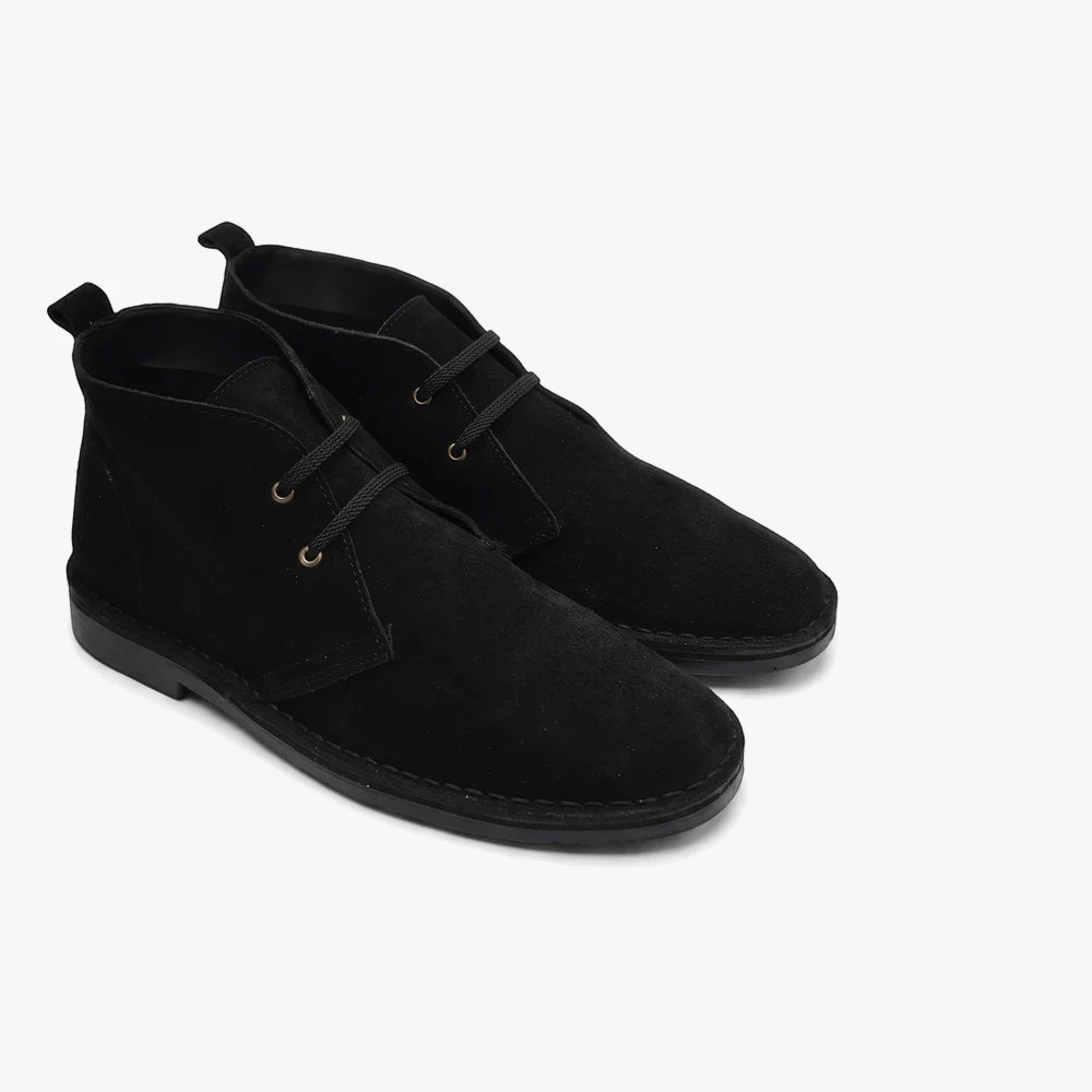 Pair of black suede Survivor Hunter Vellies lace-up desert boots with black soles, viewed from an angle on a plain