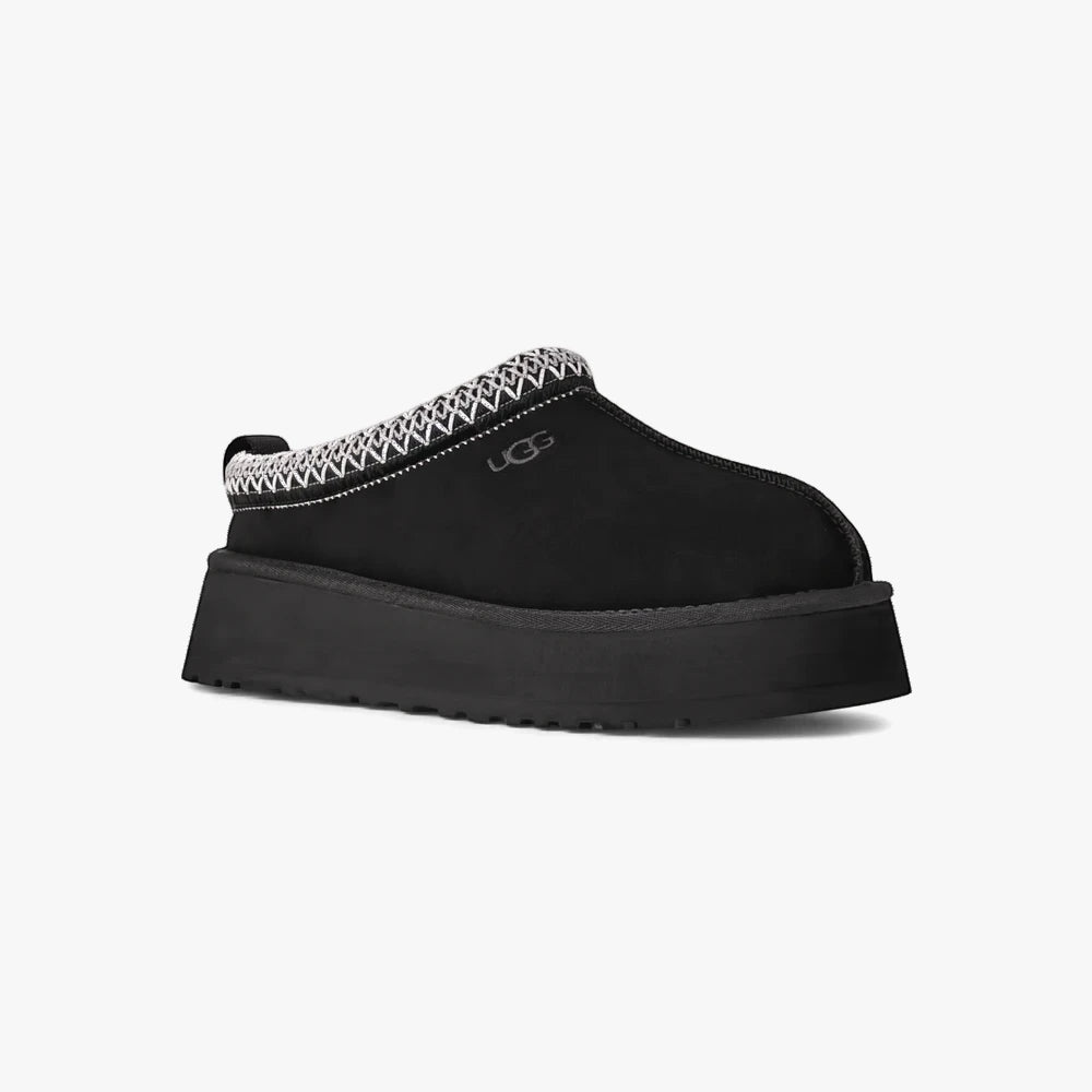 Ugg Womens Tazz II black platform slipper in profile view with distinctive white zig-zag trim around the collar.