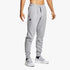 Boy wearing light gray Under Armour Rival Fleece Jogger sweatpants with an elastic waist and white sneakers.