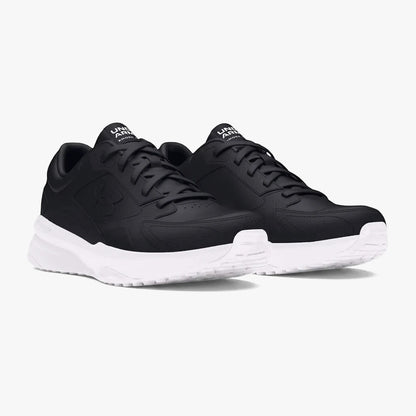 Pair of black Under Armour Mens Edge Leather Sneakers with white soles, viewed at an angle on a white background.