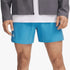 Close-up of a man wearing blue Under Armour Launch 5" athletic shorts, a white t-shirt, and a gray jacket.