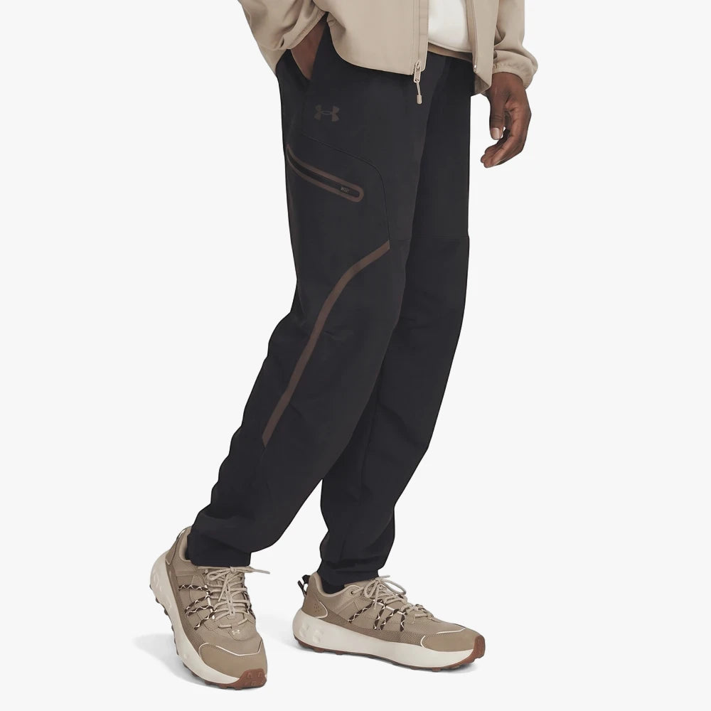 Under Armour Mens Unstoppable Cargo Pants in black, worn by a model, featuring zippered pockets and a comfortable fit,