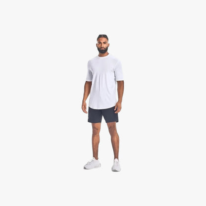 Full body image of a male model wearing Under Armour Mens Unstoppable Shorts 001 Black and a white t-shirt, standing.