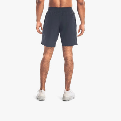 Under Armour Mens Unstoppable Shorts 001 Black on a model, seen from behind, standing in an athletic pose.