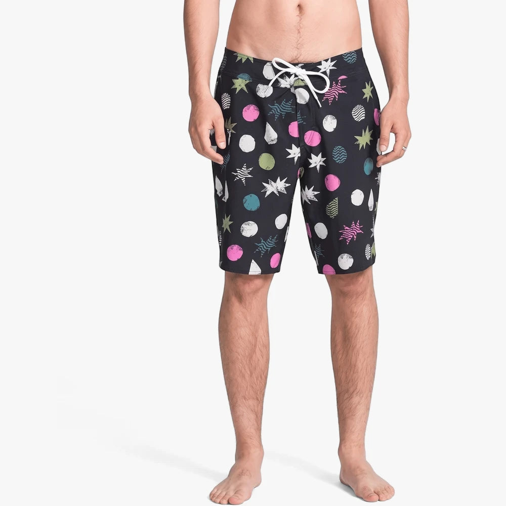 Volcom Mens Manic 20" Boardshorts in black with a vibrant multi-colored pattern and white drawstring, modeled from the waist